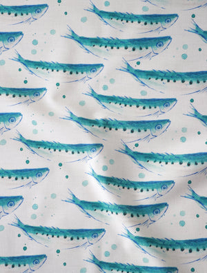 Swimming Sardines fabric by Seed Home Designs in blue and white, draped, showing swimming sardines