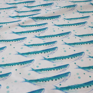 Swimming Sardines fabric by Seed Home Designs in blue and white, in soft folds showing swimming sardines