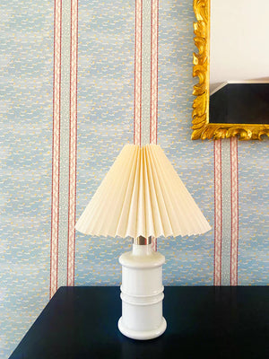 Mia wallpaper by Claire de Quénetain in pink, fine stripes above a sideboard