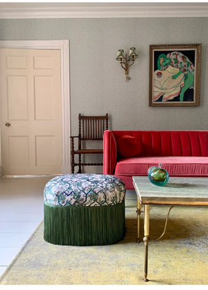 Creeping Trellis linen by Parker and Jules in green and pink, flowers on a trellis behind a sofa in a living room