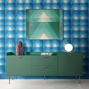 Motif wallpaper by Tatie Lou in blue, geometric pyramids above a sideboard