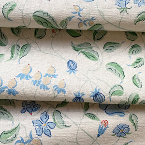 Jeanne linen by Claire de Quénetain in green, draped, showing a hand-painted floral design