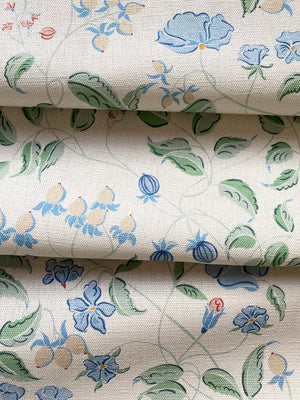 Jeanne linen by Claire de Quénetain in green, draped, showing a hand-painted floral design