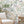 Jewel a Flutter wallpaper by Brand McKenzie in pink, birds and blossoms behind a sofa in a living room