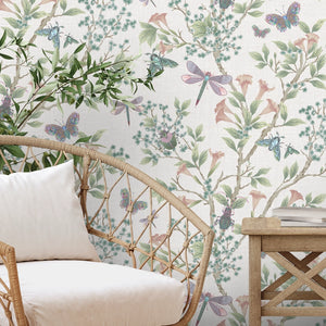 Jewel a Flutter wallpaper by Brand McKenzie in pink, birds and blossoms behind a sofa in a living room