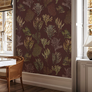 Kelp Forest Wallpaper in Garnet Red wallpaper by XV Interiors in red and green, kelp and seaweed in a styled room setting