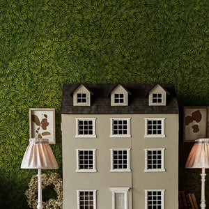Kanopea wallpaper by Deus ex Gardenia in dark green, a dense leaf canopy in a child's room