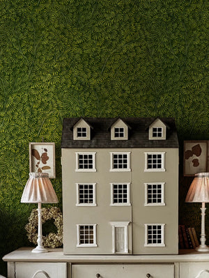 Kanopea wallpaper by Deus ex Gardenia in dark green, a dense leaf canopy in a child's room