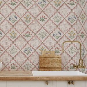 First Signs wallpaper by Studio Le Cocq in red, a floral trellis above a sideboard