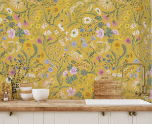 The Lost Garden Wallpaper in India Yellow wallpaper by Studio Le Cocq in yellow, a dense garden of flowers above a sideboard