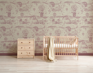 Lyons Den wallpaper by Victoria Sanders in brown, a hot-air balloon and safari toile behind a daybed in a child's room