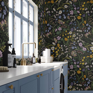 The Lost Garden wallpaper by Studio Le Cocq in black, a dense garden of flowers in a kitchen