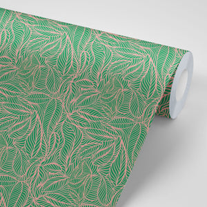 Agnes wallpaper by Tatie Lou in green and pink, partly unrolled roll showing swirling wave lines
