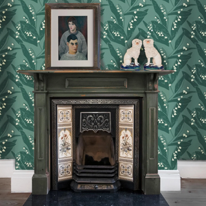 Lily of the Valley wallpaper by Annika Reed in green, lily of the valley around a fireplace