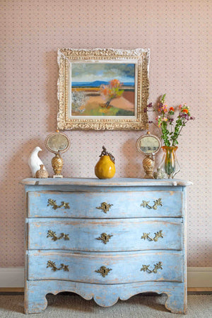 Lulu wallpaper by Parker and Jules in green and pink, a small geometric print above a sideboard