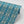 Lumiere wallpaper by Tatie Lou in teal, roll showing an Art Deco medallion