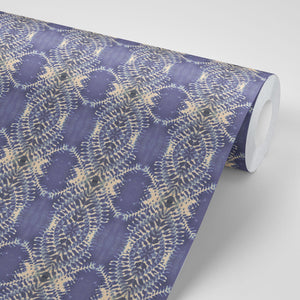 Lumiere wallpaper by Tatie Lou in lilac, partly unrolled roll showing an Art Deco medallion