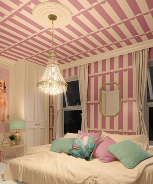 Scallop Lane wallpaper by Liberty James Studio in pink, scalloped stripes in a bedroom