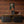Beau Burr wallpaper by Liberty James Studio in brown and orange, a burr wood grain design in a home office