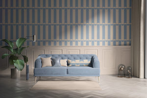 Scallop Lane wallpaper by Liberty James Studio in blue, scalloped stripes behind a sofa in a living room