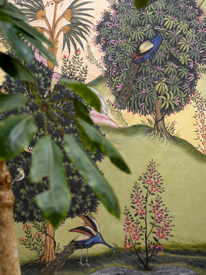 Mayura Valley wallpaper by Deus ex Gardenia in sage green and yellow, close view of a peacock valley mural