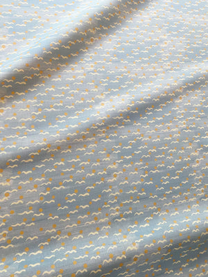 Malo linen by Claire de Quénetain in yellow, in soft folds showing scattered tiny motifs