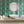 Marco Island wallpaper by Liberty James Studio in green, a scrolling damask design in a bathroom