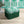 Marco Island Eco velvet by Liberty James Studio in green, a scrolling damask design on an upholstered ottoman