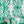 Marco Island wallpaper by Liberty James Studio in green, partly unrolled roll showing a scrolling damask design