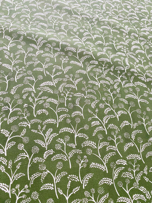 Margaux linen by Claire de Quénetain in green, draped close-up of delicate sprigs