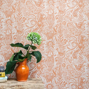 Squirrel and Sunflower wallpaper by St. Jude's in pink, squirrels and sunflowers behind a console table