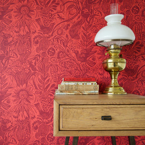 Squirrel and Sunflower wallpaper by St. Jude's in red, squirrels and sunflowers above a cabinet
