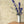 Wren wallpaper by St. Jude's in beige, wrens among leaves behind a console table