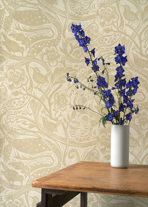 Wren wallpaper by St. Jude's in beige, wrens among leaves behind a console table
