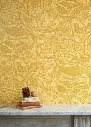 Wren wallpaper by St. Jude's in yellow, wrens among leaves above a sideboard