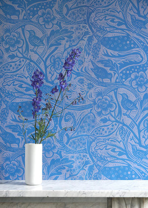 Wren wallpaper by St. Jude's in blue, wrens among leaves above a cabinet