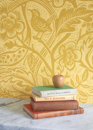 Wren wallpaper by St. Jude's in yellow, wrens among leaves above a cabinet