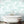 Mermaids wallpaper by Dupenny in pale green, mermaids and waves on a bathroom wall
