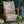 Metamorphasis linen by The Monkey Puzzle Tree in grey and green, a metamorphosis design upholstered on an armchair
