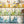 Mixology wallpaper by Brand McKenzie in cream, shelves of colourful bottles above kitchen cabinets