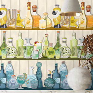 Mixology wallpaper by Brand McKenzie in cream, shelves of colourful bottles above kitchen cabinets