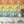Mixology wallpaper by Brand McKenzie in multicolour, pattern detail of shelves of colourful bottles