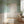 Blossom Veil wallpaper by Dami and Em Design in pale green, trailing blossom garlands in a hallway