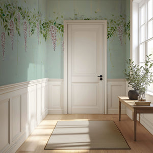 Blossom Veil wallpaper by Dami and Em Design in pale green, trailing blossom garlands in a hallway