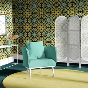 Molten Mosaic wallpaper by Liberty James Studio in yellow, green and blue behind a sofa in a living room