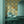 Molten Mosaic wallpaper by Liberty James Studio in yellow, green and blue, a kaleidoscope mosaic in a living room