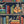 Monkey Library wallpaper by Brand McKenzie in blue, pattern detail of monkeys in a bookcase