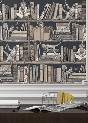 Monkey Library wallpaper by Brand McKenzie in taupe, monkeys in a bookcase behind a desk in a home office