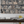 Monkey Library wallpaper by Brand McKenzie in taupe, monkeys in a bookcase above a work desk