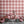 Santorini Tile wallpaper by Liberty James Studio in pink and white, roll showing a Mediterranean tile pattern